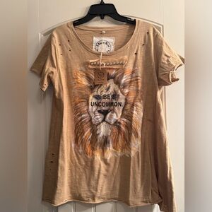 A Rare Bird women’s lion “Be Uncommom” tan distressed shirt.  Size S /M NWT